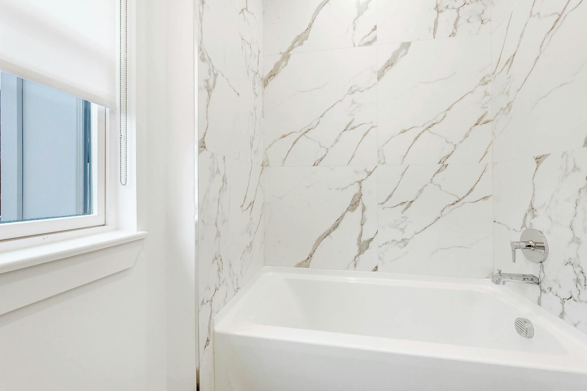 74 Clarendon Place, Unit 202 Hackensack, NJ 07601 - Photo 19 of 33 a bathroom with bathtub and shower