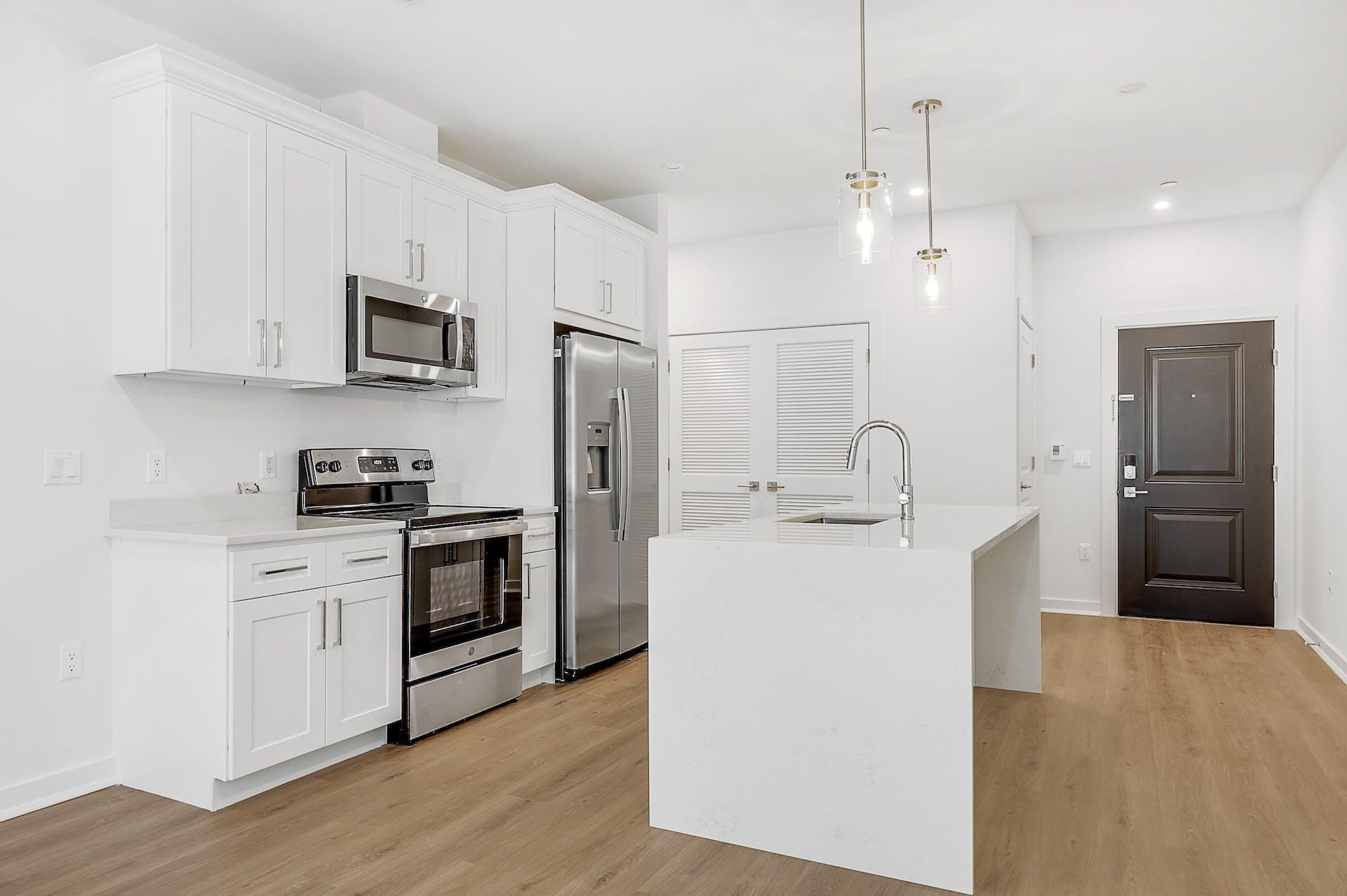 74 Clarendon Place, Unit 202 Hackensack, NJ 07601 - Photo 2 of 33 a kitchen with stainless steel appliances a refrigerator sink and white cabinets