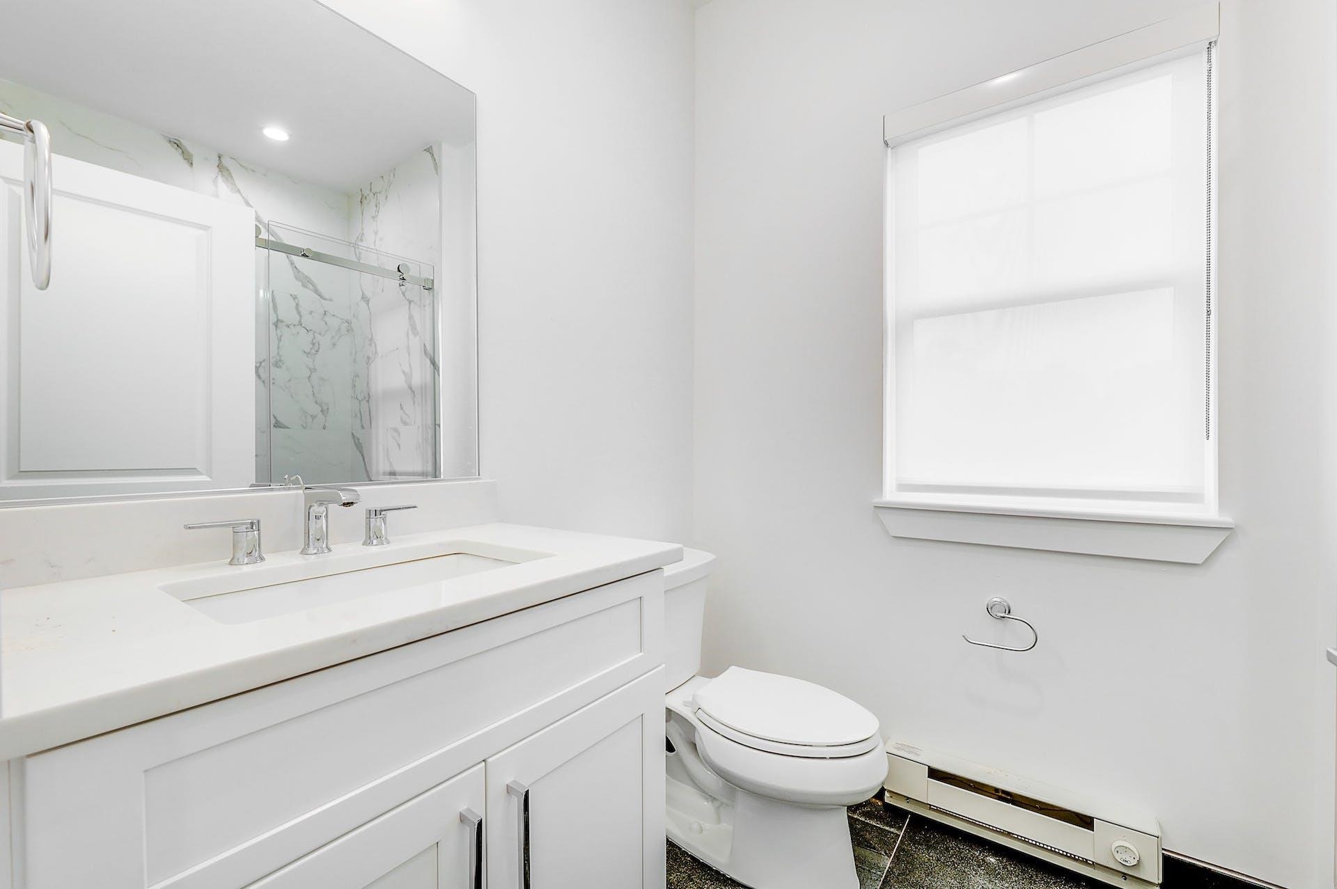 74 Clarendon Place, Unit 202 Hackensack, NJ 07601 - Photo 21 of 33 a bathroom with a sink and a mirror