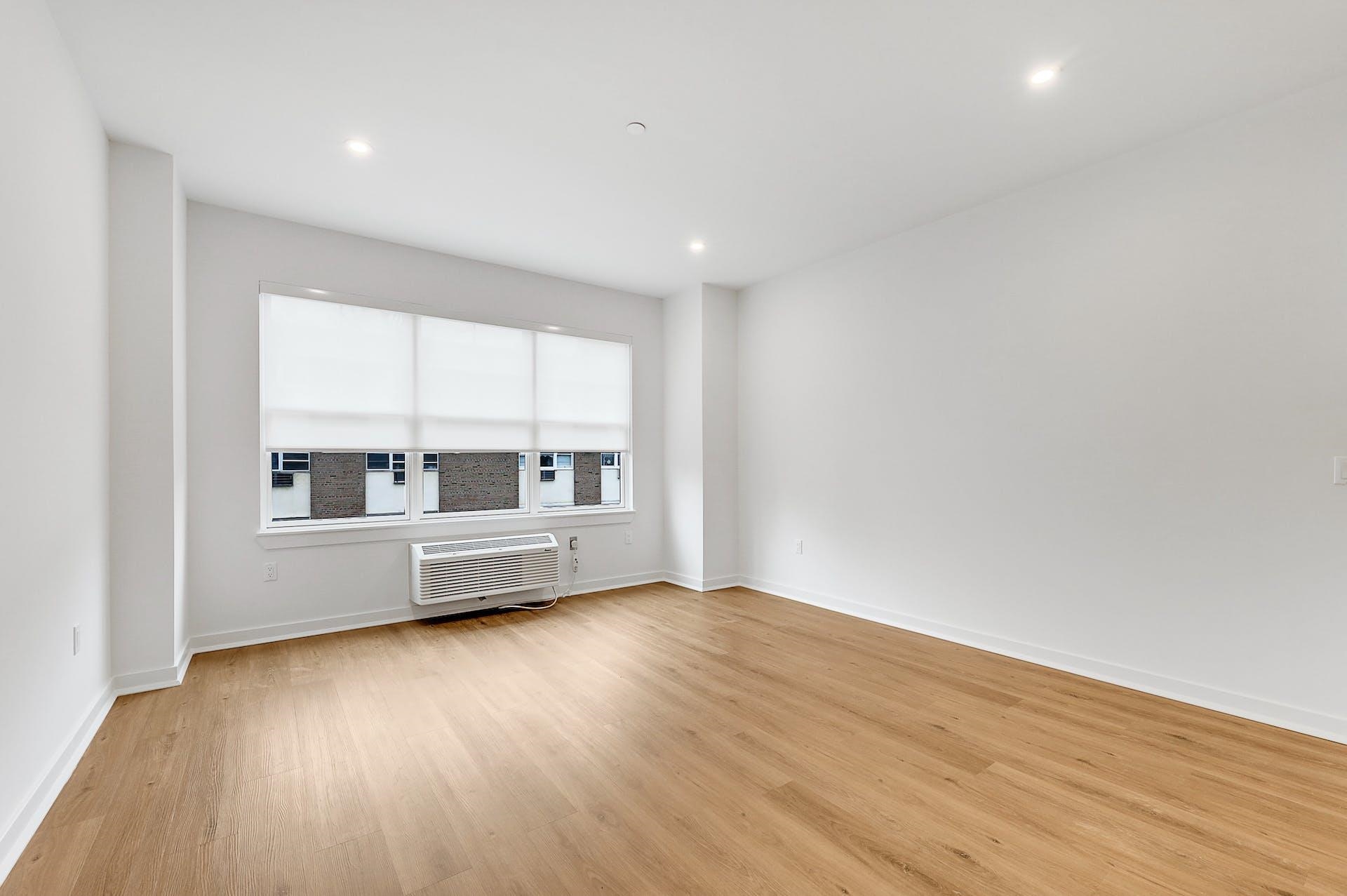 74 Clarendon Place, Unit 202 Hackensack, NJ 07601 - Photo 8 of 33 a view of an empty room with a window and wooden floor