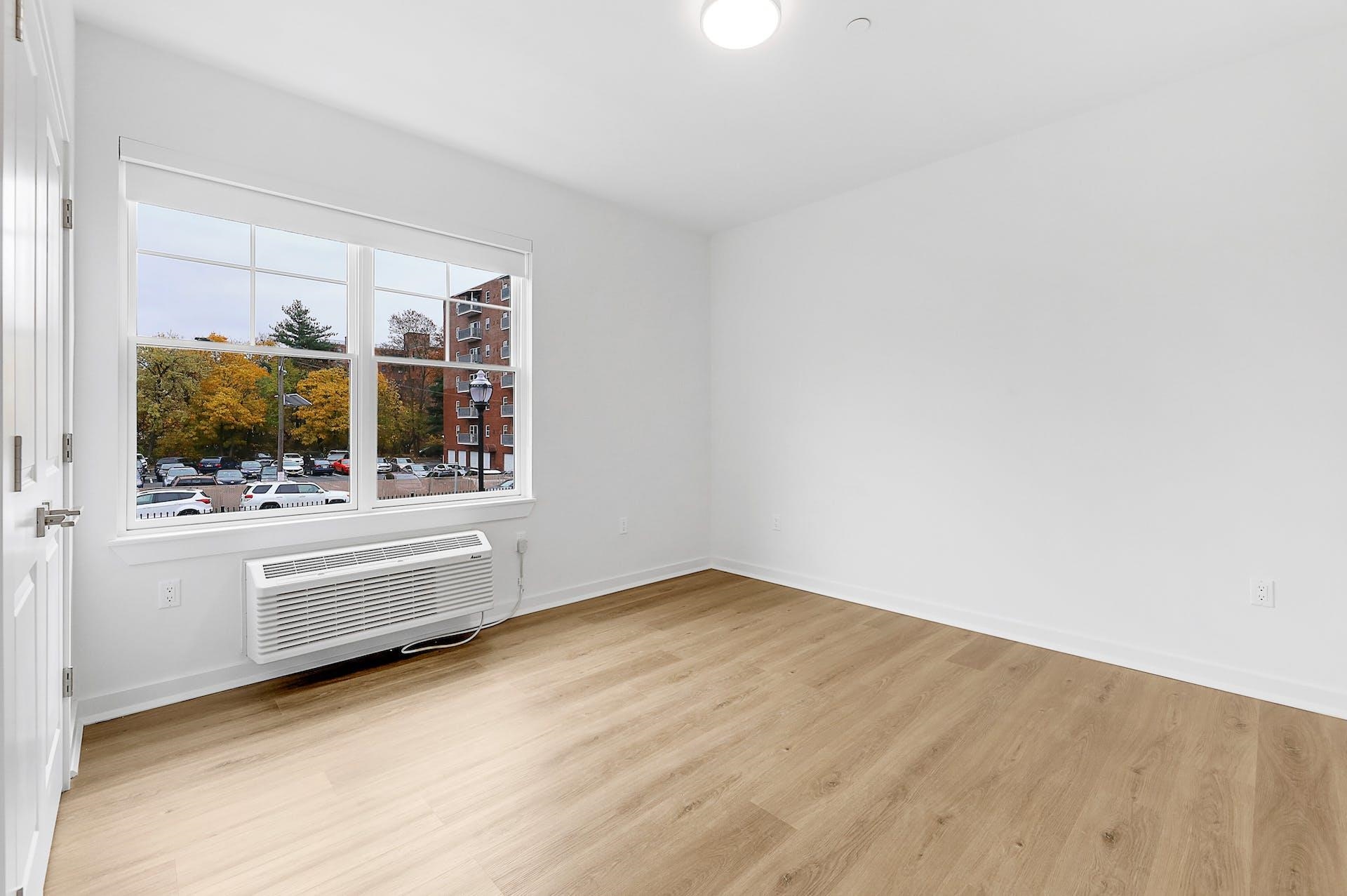 74 Clarendon Place, Unit 202 Hackensack, NJ 07601 - Photo 10 of 33 a view of empty room with wooden floor and fan