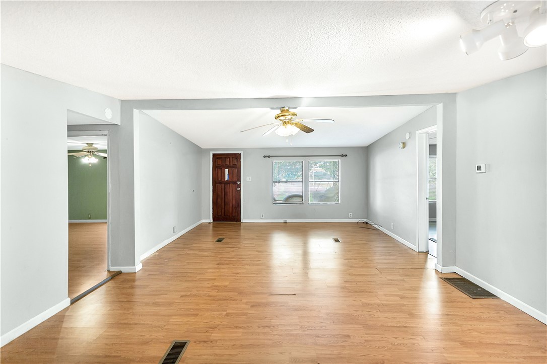 1004 Wiles Road Anderson, SC 29625 - Photo 7 of 26 Natural light illuminates the generous living space, highlighting the beautiful wood flooring.