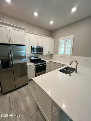 a kitchen with a sink a stove and refrigerator