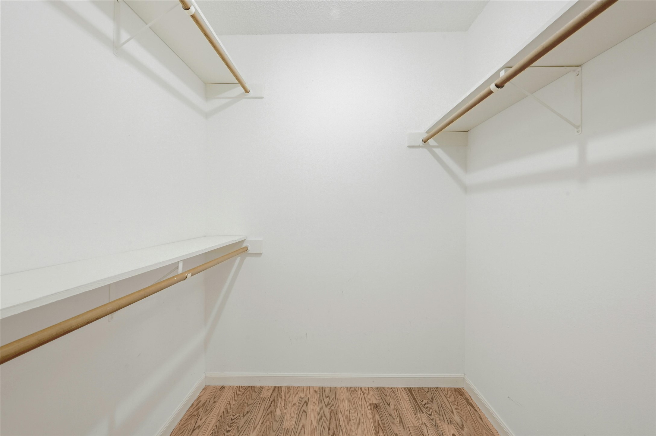 9226 Jollyville Road, Unit 221 Austin, TX 78759 - Photo 17 of 20 Ample shelving and hanging space in this well-appointed closet, featuring durable wood flooring.