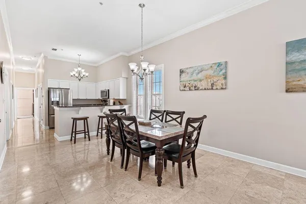 a view of a dining room and livingroom with furniture window and wooden floor
