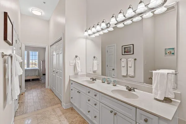 a bathroom with a tub sink and mirror