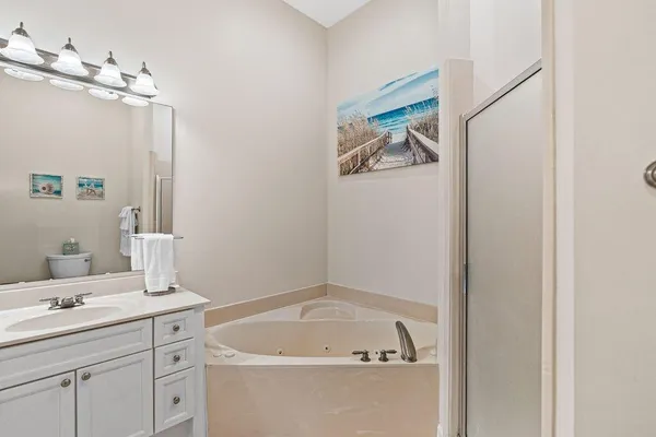 a bathroom with a sink a toilet and shower curtain