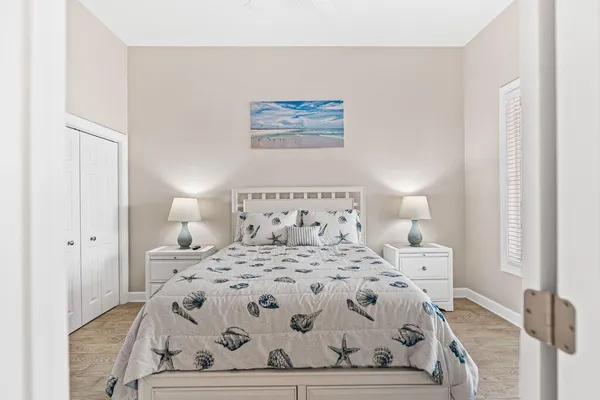 a bedroom with a large bed and a painting on the wall