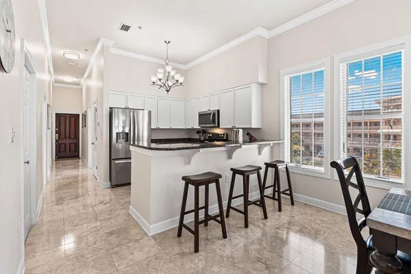a view of a dining room with furniture and a chandelier