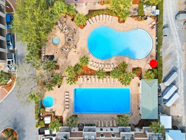 a view of swimming pool with outdoor seating and plants