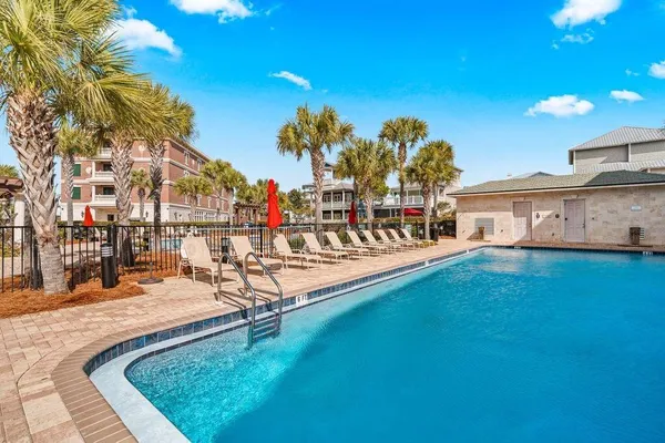 a swimming pool with outdoor seating and yard
