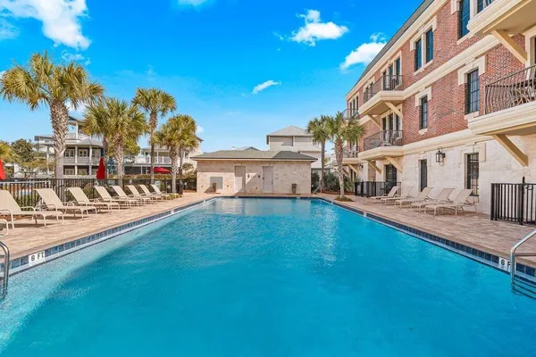 a view of a house with pool and sitting area