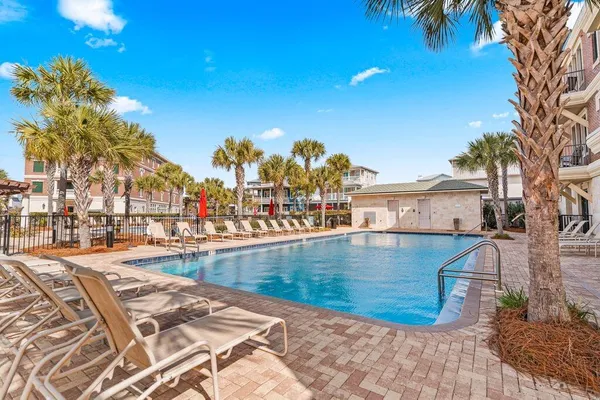a view of a patio with couches and table and chairs and potted plants