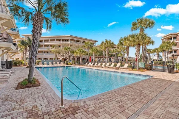 a view of a patio with iron fence