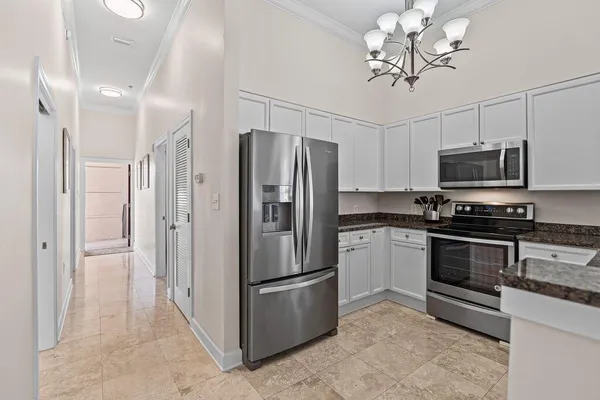 a kitchen with stainless steel appliances granite countertop a refrigerator a stove top oven a sink and dishwasher