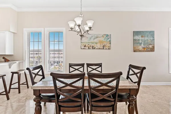 a view of a dining room with furniture and chandelier