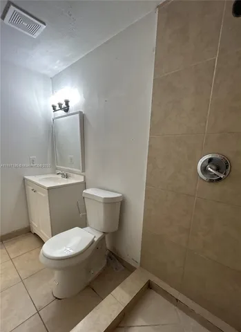 a white toilet sitting next to a bathroom sink
