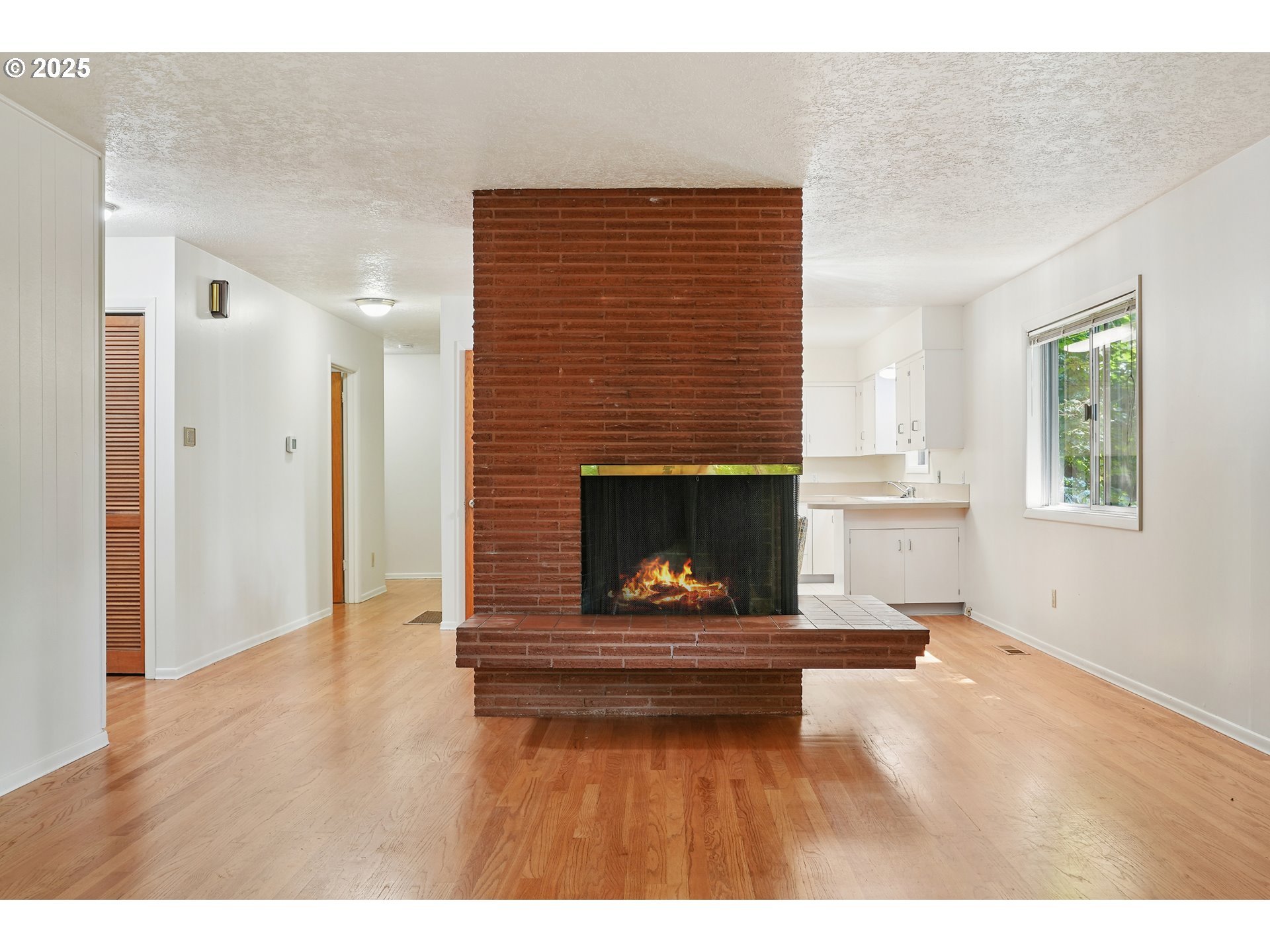 3270 Southwest Fairmount Boulevard Portland, OR 97239 - Photo 12 of 48 a view of an empty room with a fireplace and window