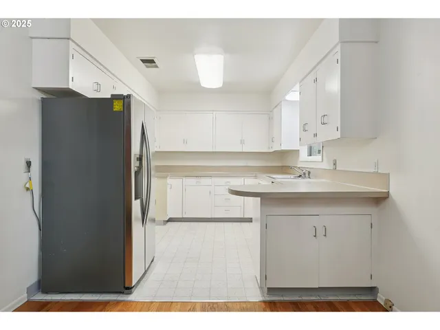 a kitchen with a sink and a refrigerator