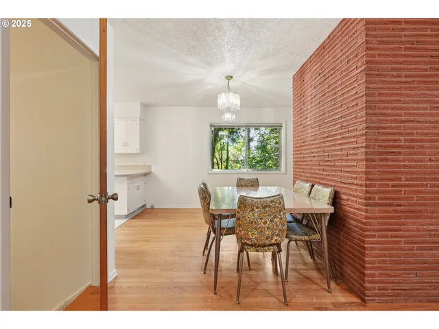 a view of a dining room with furniture and a chandelier