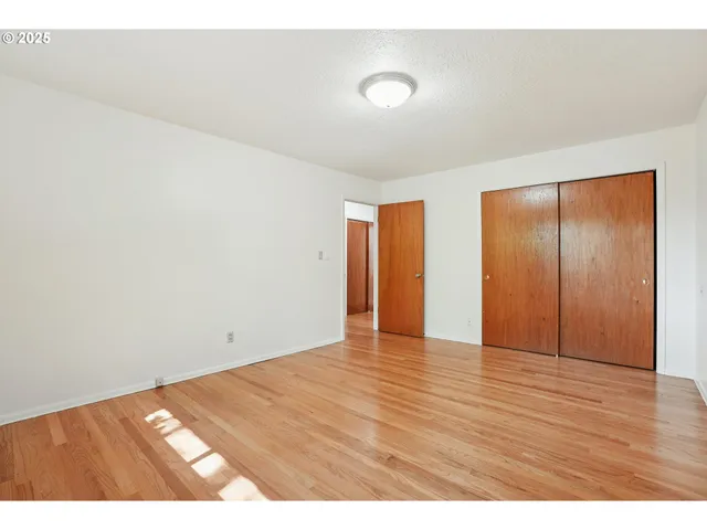 a view of an empty room and wooden floor