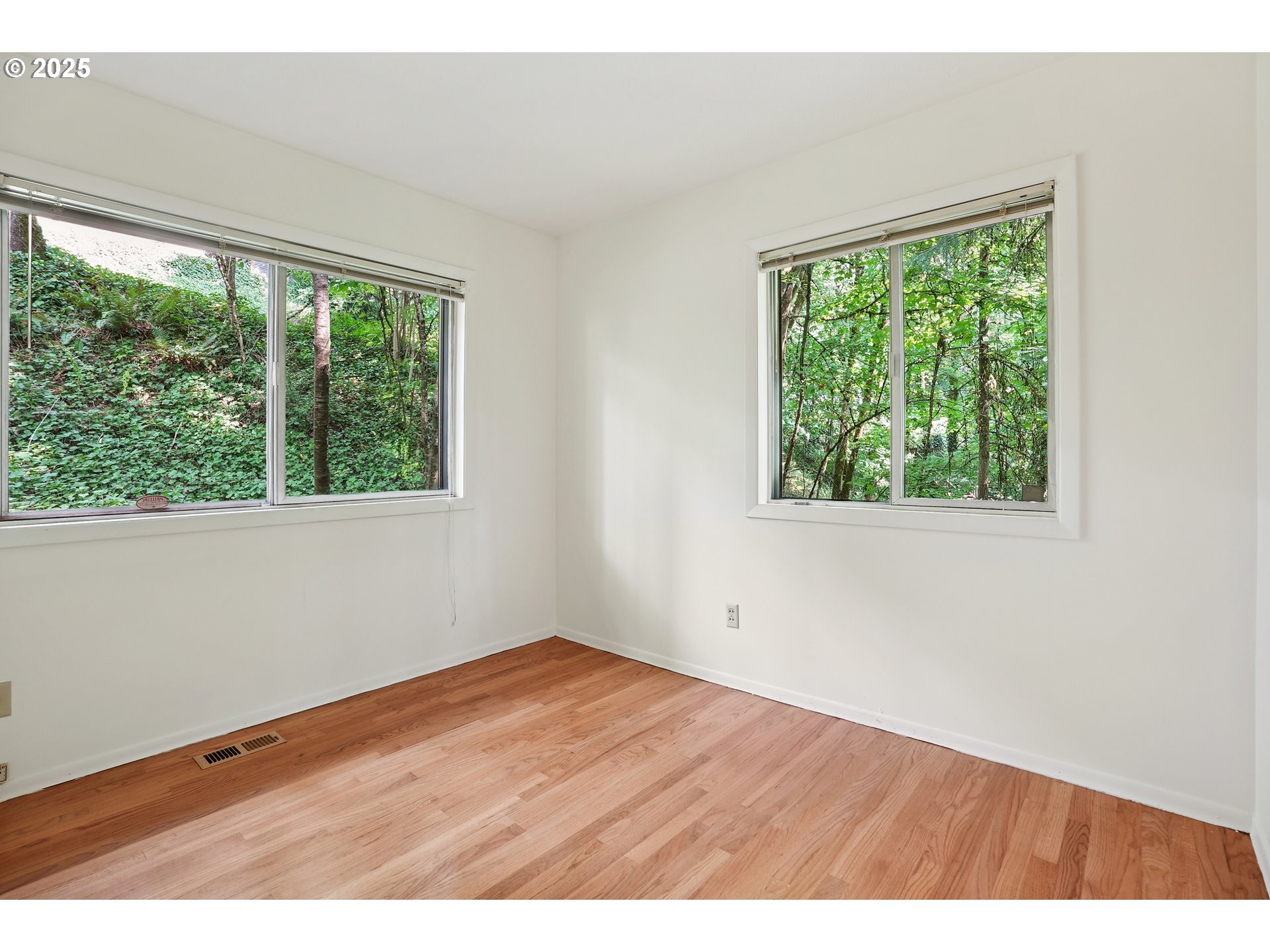3270 Southwest Fairmount Boulevard Portland, OR 97239 - Photo 23 of 48 an empty room with wooden floor and windows