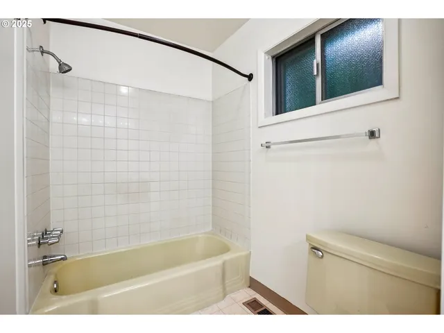 a bathroom with a tub and a shower