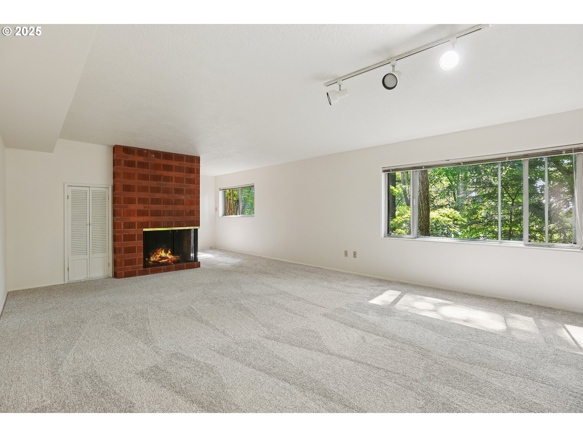 3270 Southwest Fairmount Boulevard Portland, OR 97239 - Photo 30 of 48 a view of an empty room with a fireplace and a window