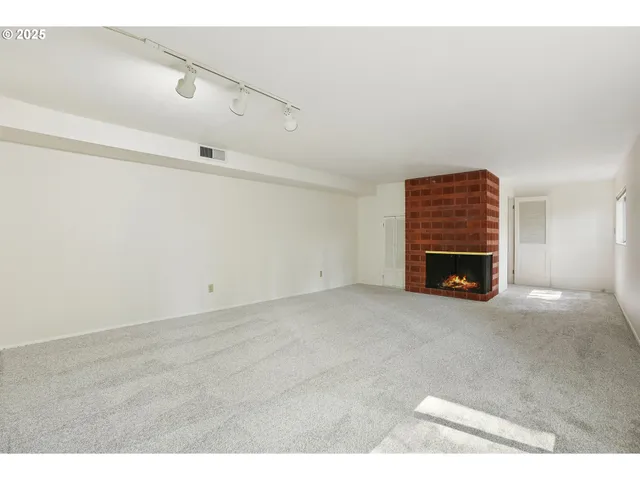 a view of empty room with a fireplace