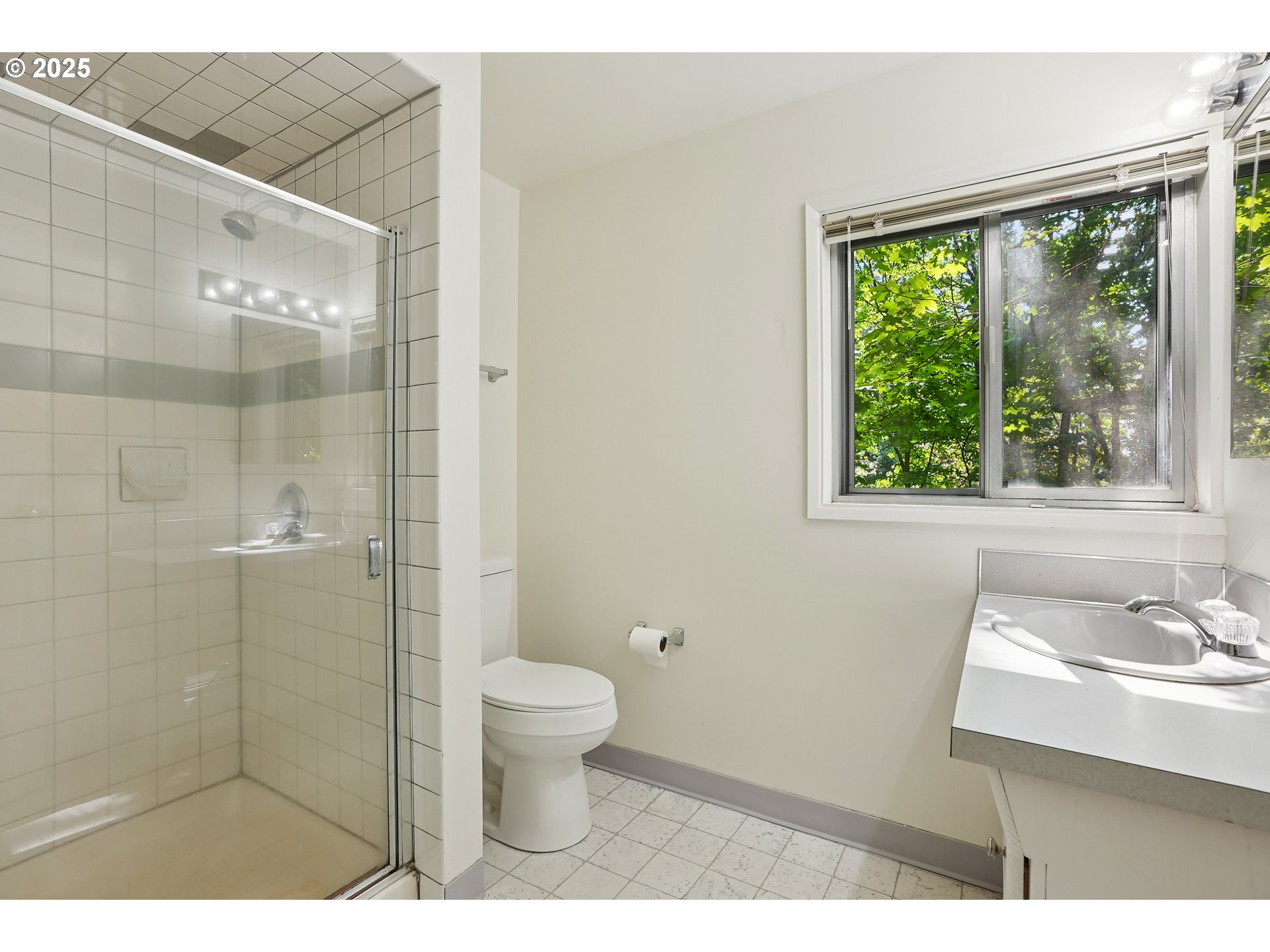 3270 Southwest Fairmount Boulevard Portland, OR 97239 - Photo 32 of 48 a bathroom with a sink a toilet and a shower