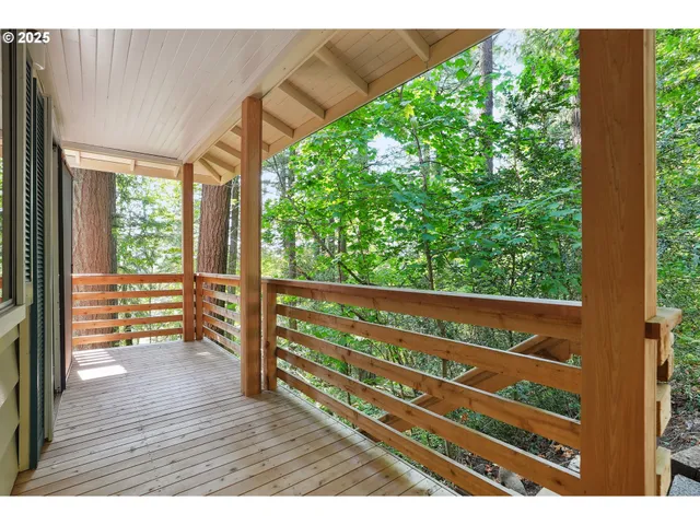 a view of backyard with deck and outdoor seating