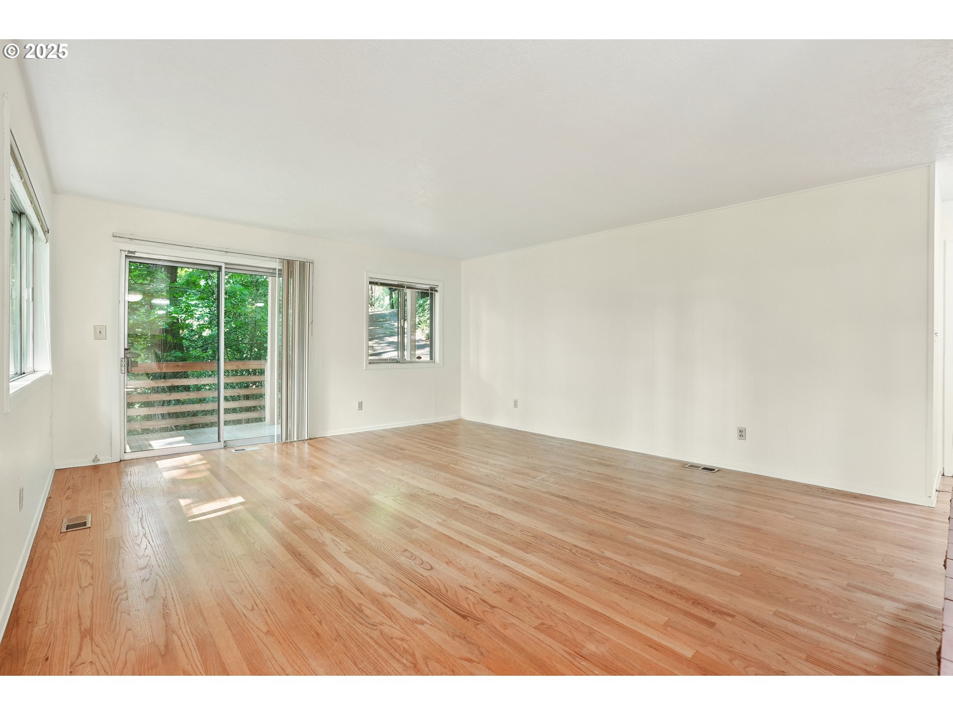 3270 Southwest Fairmount Boulevard Portland, OR 97239 - Photo 10 of 48 a view of an empty room with wooden floor and a window