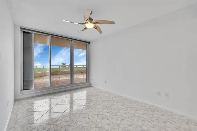a spacious bathroom with a granite countertop sink a toilet and a mirror