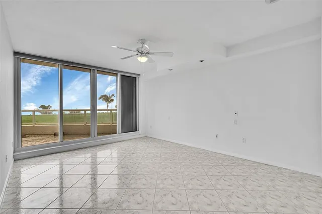a front view of a building with a garden and plants