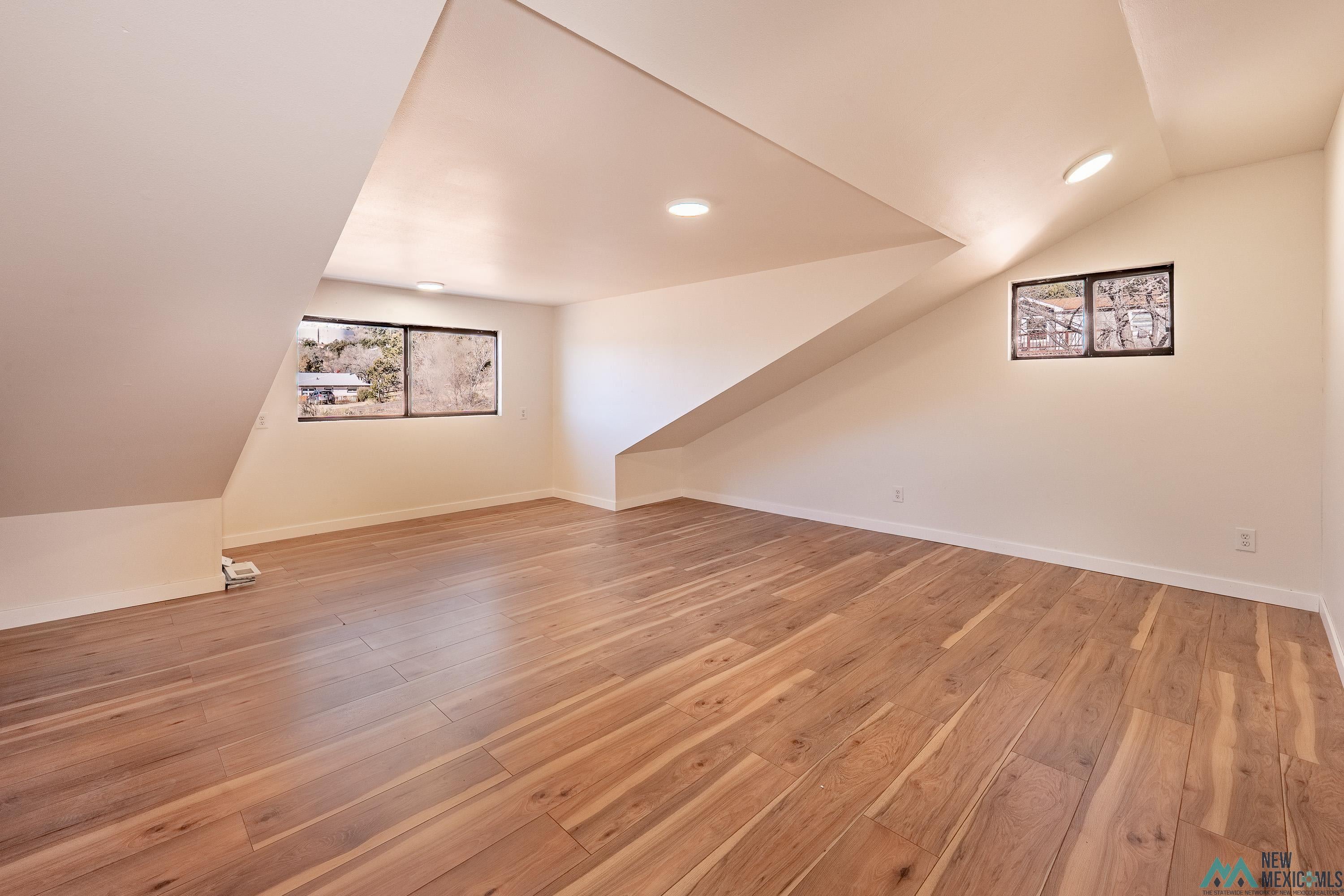 1131 Lincoln Avenue Raton, NM 87740 - Photo 12 of 41 Bonus room with lofted ceiling, light wood-style floors, and recessed lighting