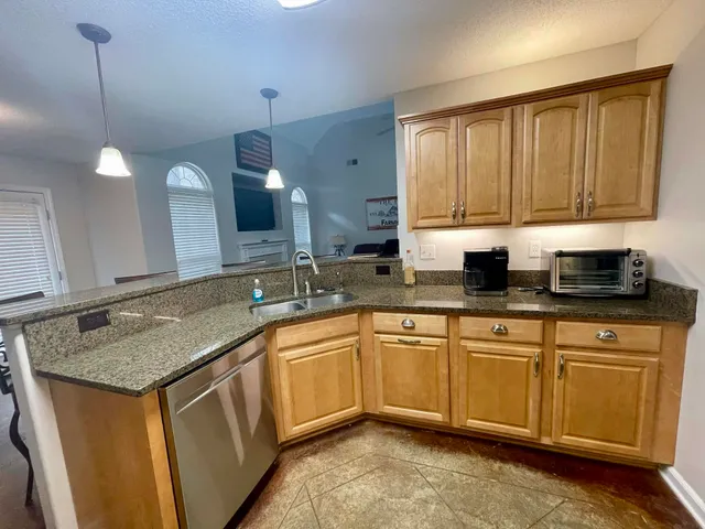 a kitchen with stainless steel appliances a stove microwave and a refrigerator