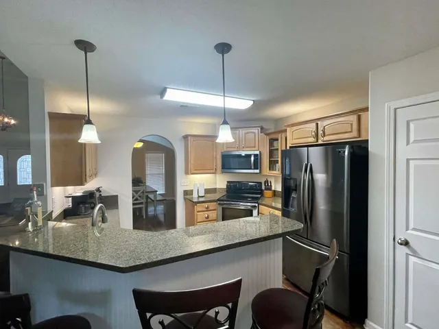 a kitchen with a sink stove and cabinets