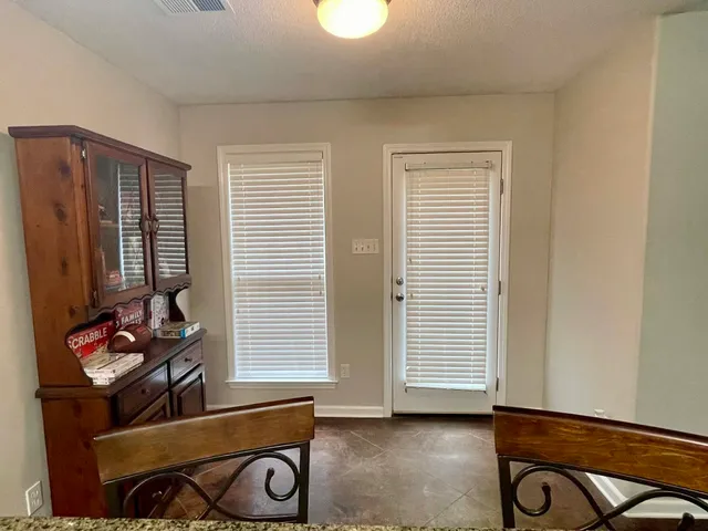 a kitchen with refrigerator and window