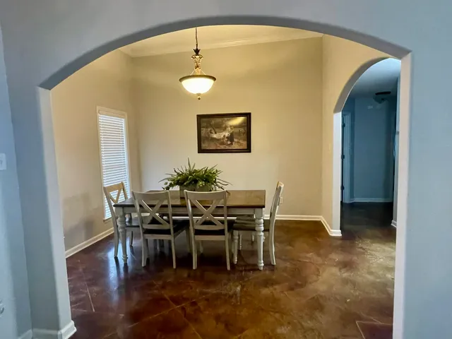 a view of a dining room with furniture and chandelier