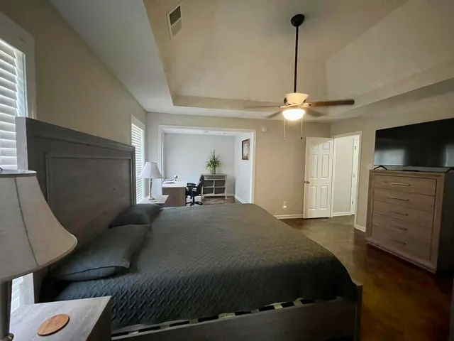 a bedroom with a bed and a flat screen tv