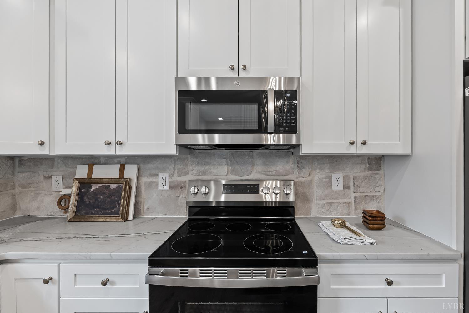 2441 River Road Madison Heights, VA 24572 - Photo 13 of 45 a kitchen with stainless steel appliances granite countertop white cabinets and a stove