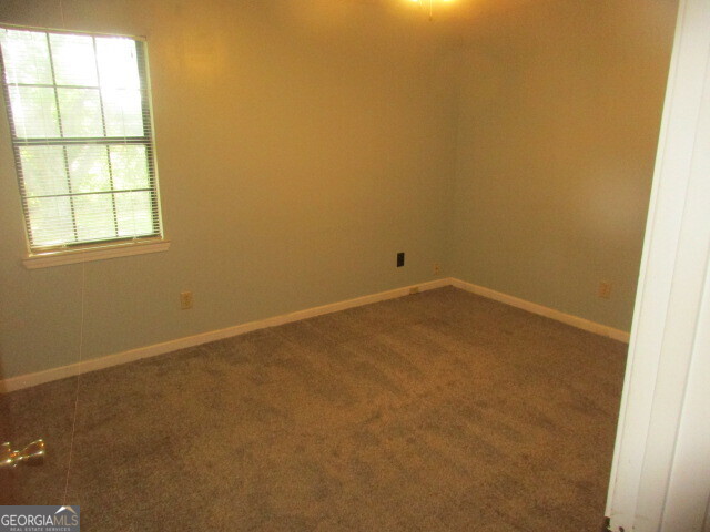 625 Strickland Road Locust Grove, GA 30248 - Photo 7 of 11 an empty room with a window