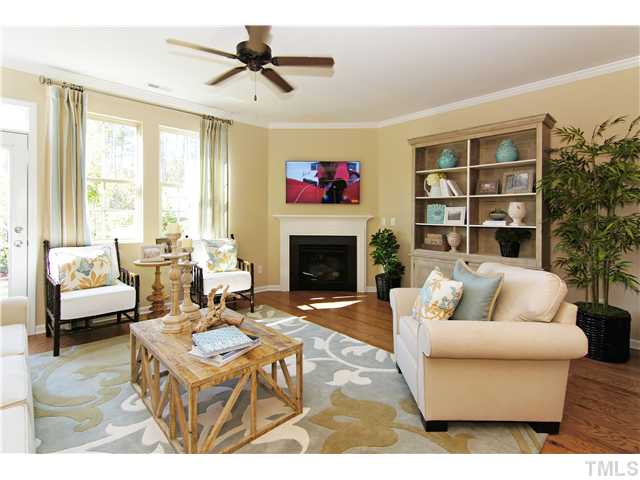 759 Wickham Ridge Road, Unit 105 Apex, NC 27539 - Photo 13 of 25 a living room with furniture and a fireplace