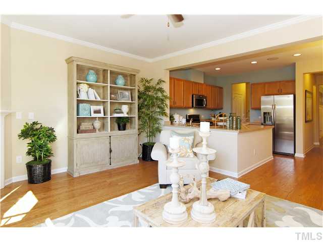 759 Wickham Ridge Road, Unit 105 Apex, NC 27539 - Photo 14 of 25 a living room with furniture and a potted plant