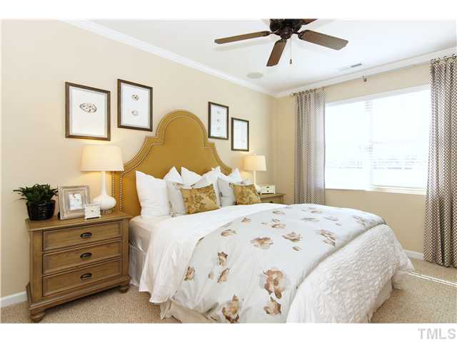 759 Wickham Ridge Road, Unit 105 Apex, NC 27539 - Photo 15 of 25 a bedroom with a bed and wooden floor