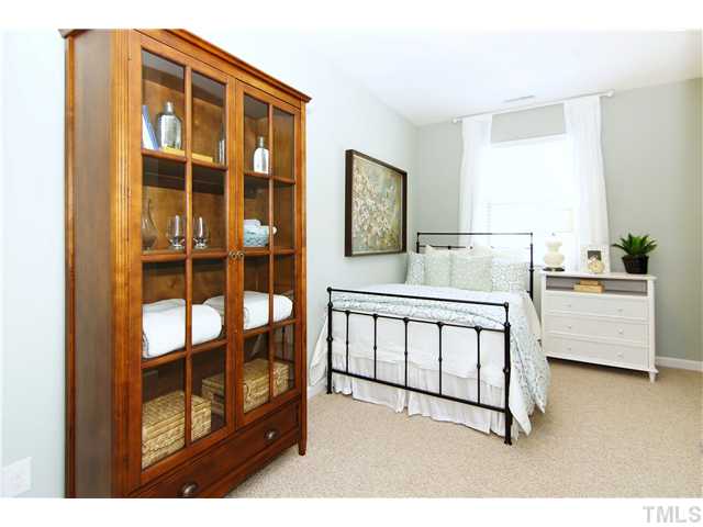 759 Wickham Ridge Road, Unit 105 Apex, NC 27539 - Photo 18 of 25 a bedroom with furniture and a window