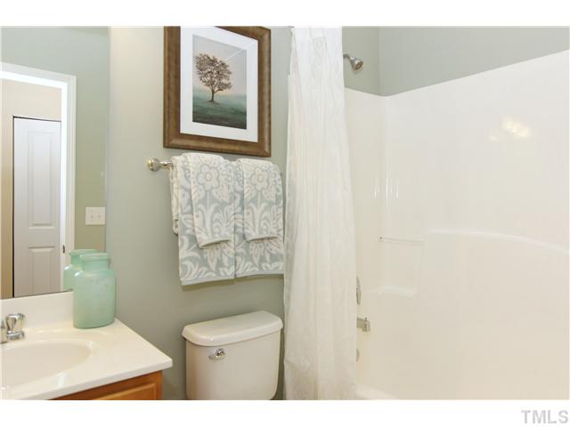 759 Wickham Ridge Road, Unit 105 Apex, NC 27539 - Photo 20 of 25 a bathroom with a toilet and a sink