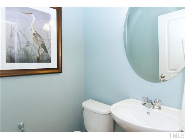 759 Wickham Ridge Road, Unit 105 Apex, NC 27539 - Photo 23 of 25 a bathroom with a toilet and a sink