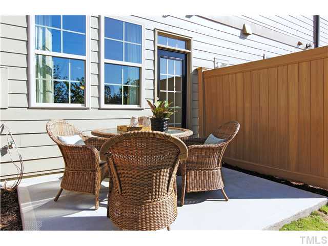 759 Wickham Ridge Road, Unit 105 Apex, NC 27539 - Photo 24 of 25 a view of a chair and table in the patio