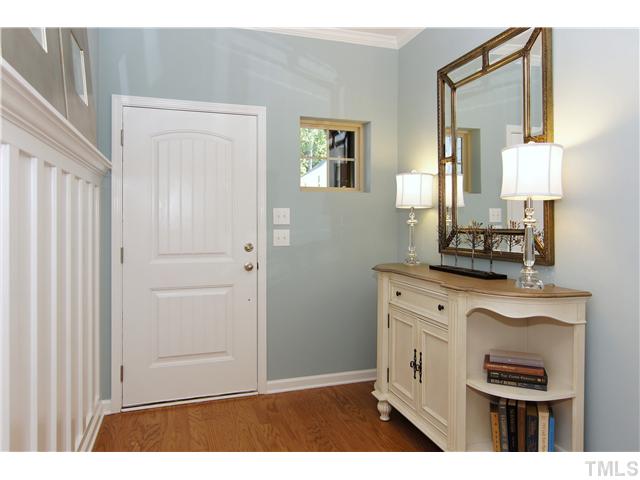 759 Wickham Ridge Road, Unit 105 Apex, NC 27539 - Photo 3 of 25 a kitchen with cabinets and a wooden floor